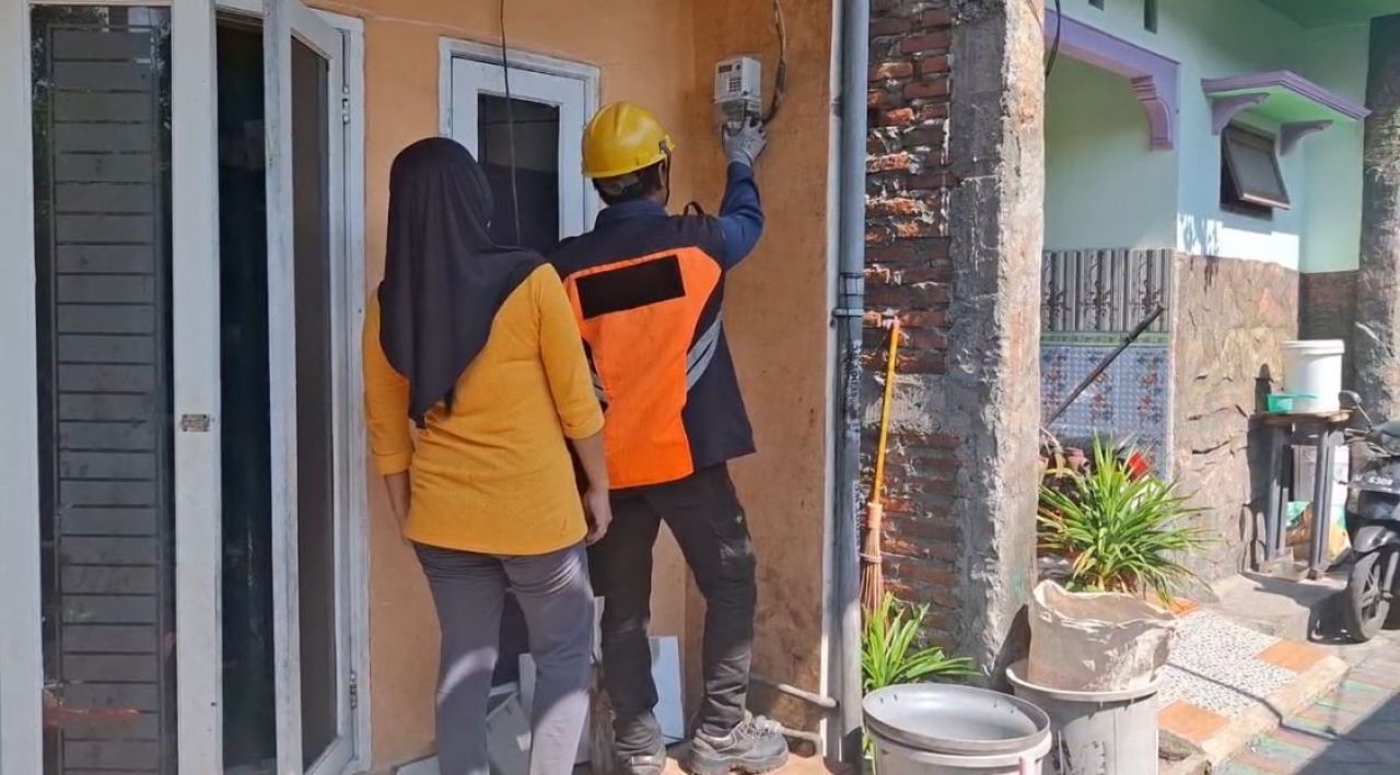 Personel PLN melakukan tambah daya ke salah satu pelanggan. (Foto: PLN for Jatimkini.com)