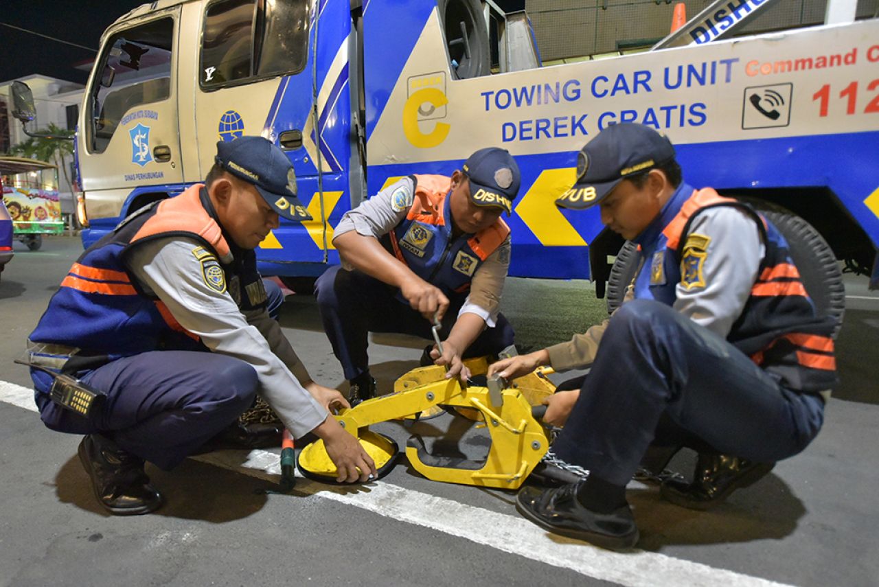 Petugas Dishub Surabaya saat menyiapkan gembok mobil sebagai bentuk penindakan terhadap parkir liar di kawasan Kota Lama. (Foto-foto: Humas Pemkot Surabaya for jatimkini.com)