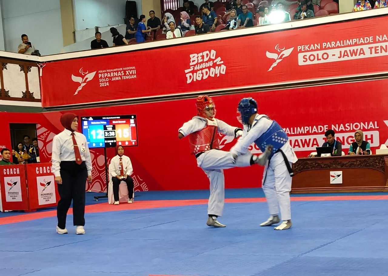 Ria Yulianti ( Merah ) atlet taekwondo Jatim berhasil lolos ke final usai mengalahkan  atlet taekwondo Sumut di ajang papernas 2024 ( Foto : Jatimkini.com/Ali Topan)
