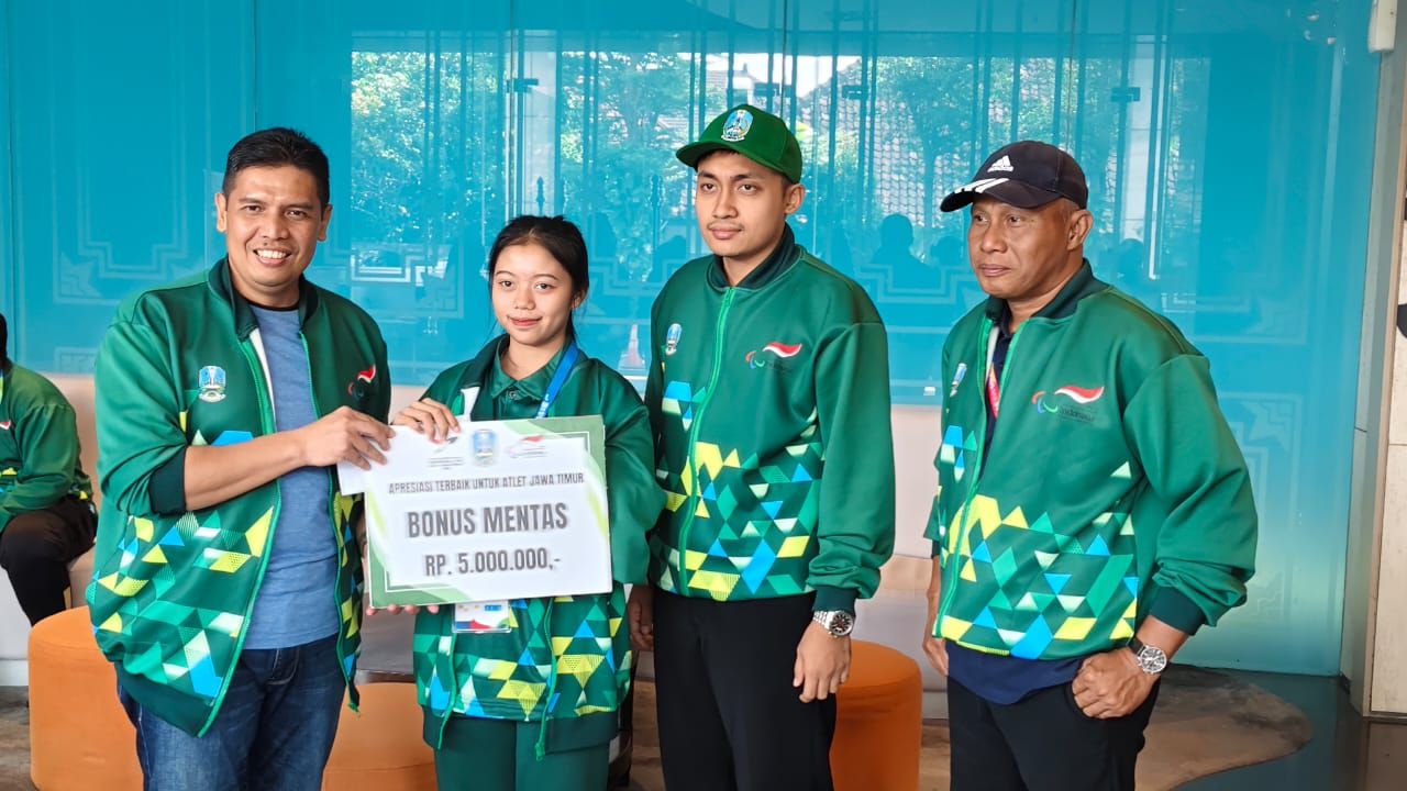 Kadispora Jatim Muhamad Hadi Wawan Guntoro sat menyerahkan bonus mentas pada atlet para Taekwondo Jatim Ria Yulianti, di Solo ( Foto : Jatimkini.com/Ali Topan)