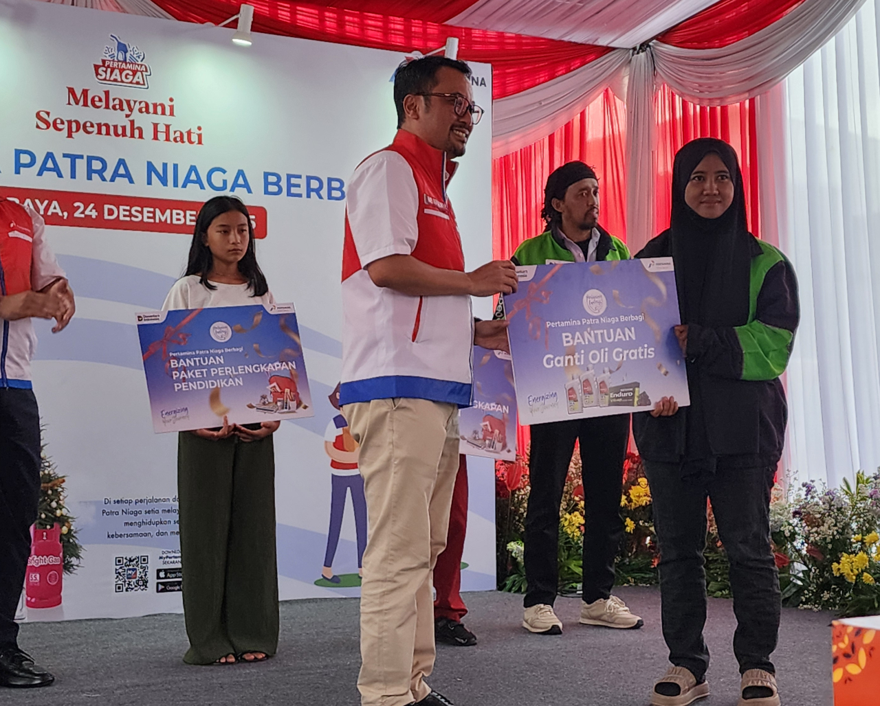 Dirut Pertamina Patra Niaga Mars Ega Legowo Putra secara simbolis menyerahkan bantuan ganti oli gratis bagi ojol Surabaya. Foto : Peni Widarti