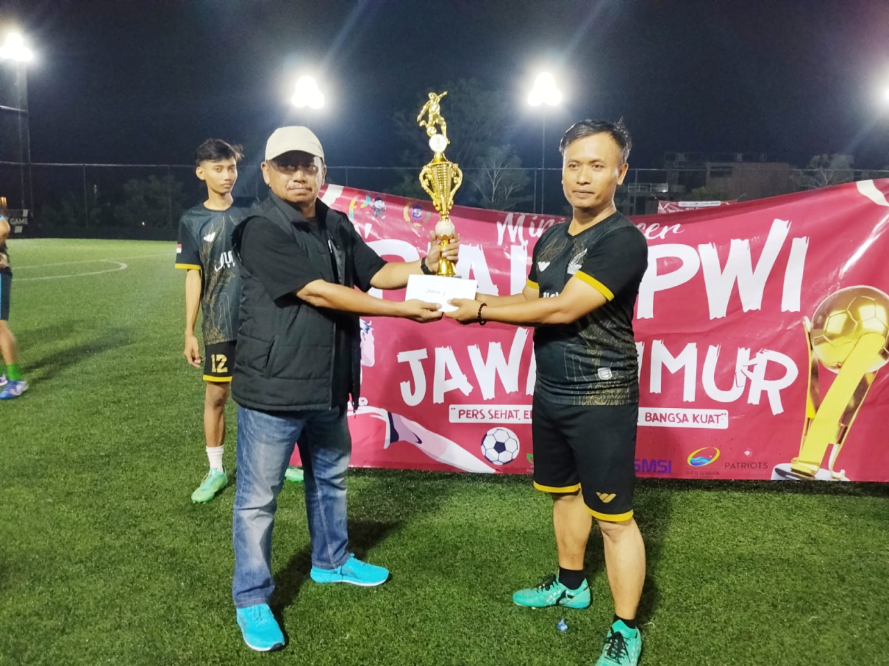 Ketua PWI Jatim Lutfil Hakim memberikan piala turnamen Minisoccer antar Pokja wartawan di Surabaya ( Foto : Soemadji / Jatimkini.com )